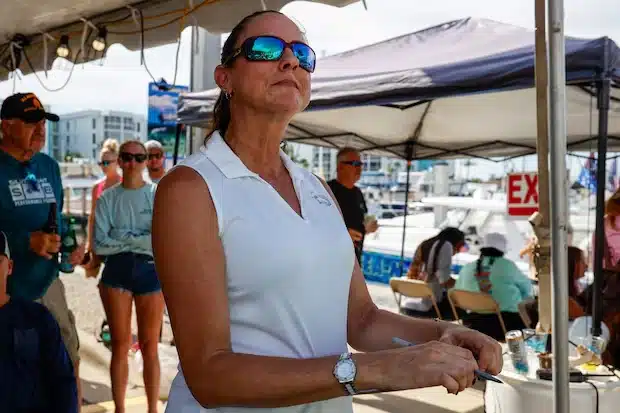 Erika Almond, the tournament director, watches teams weigh their fish during the Suncoast Ladies’ Classic at Tiki Docks Skyway Bar and Grill on July 13 in St. Petersburg. [ JEFFEREE WOO | Times ]