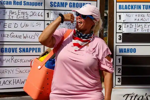 Crystal Snead, with the Reel Dream Team, celebrates after her team finishes weighing their fish at the Tiki Docks Skyway Bar and Grill during the Suncoast Ladies’ Classic on July 13 in St. Petersburg. [ JEFFEREE WOO | Times ]