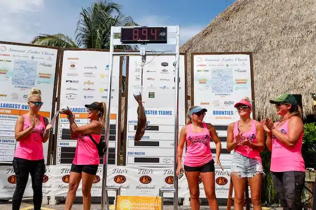 The Not Here For A Haircut team celebrates when their scamp grouper weighs 8.94 pounds during the Suncoast Ladies’ Classic at Tiki Docks Skyway Bar and Grill on July 13 in St. Petersburg. [ JEFFEREE WOO | Times ]