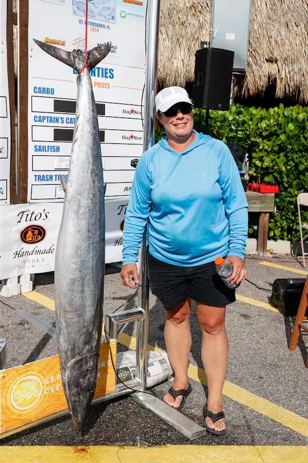 Jenny Roesch of St. Petersburg stands next to a wahoo that she caught that weighed 63.8 pounds during the Suncoast Ladies’ Classic at Tiki Docks Skyway Bar and Grill on July 13 in St. Petersburg. [ JEFFEREE WOO | Times ]